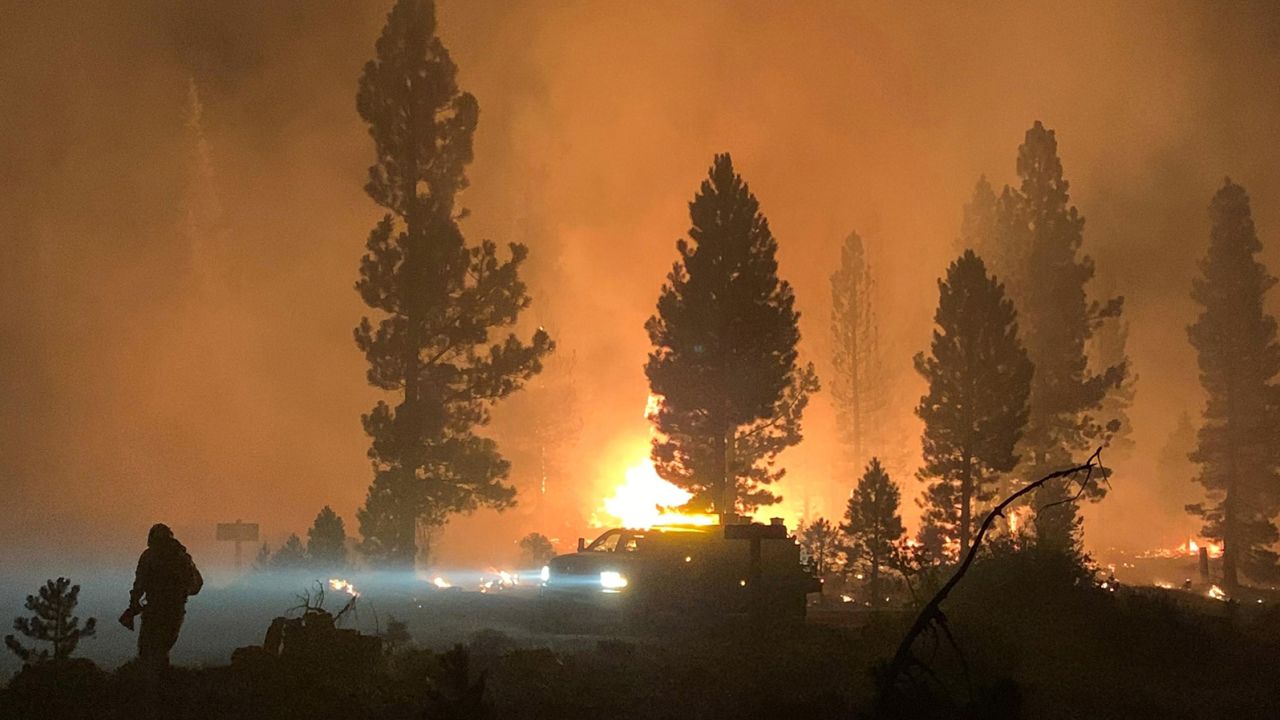 In this photo provided by the Bootleg Fire Incident Command, the Bootleg Fire burns at night in southern Oregon on Saturday, July 17, 2021. The destructive Bootleg Fire, one of the largest in modern Oregon history, has already burned more than 476 square miles (1,210 square kilometers), an area about the size of Los Angeles. The Bootleg Fire is among dozens burning in the parched West.  (Bootleg Fire Incident Command via AP)