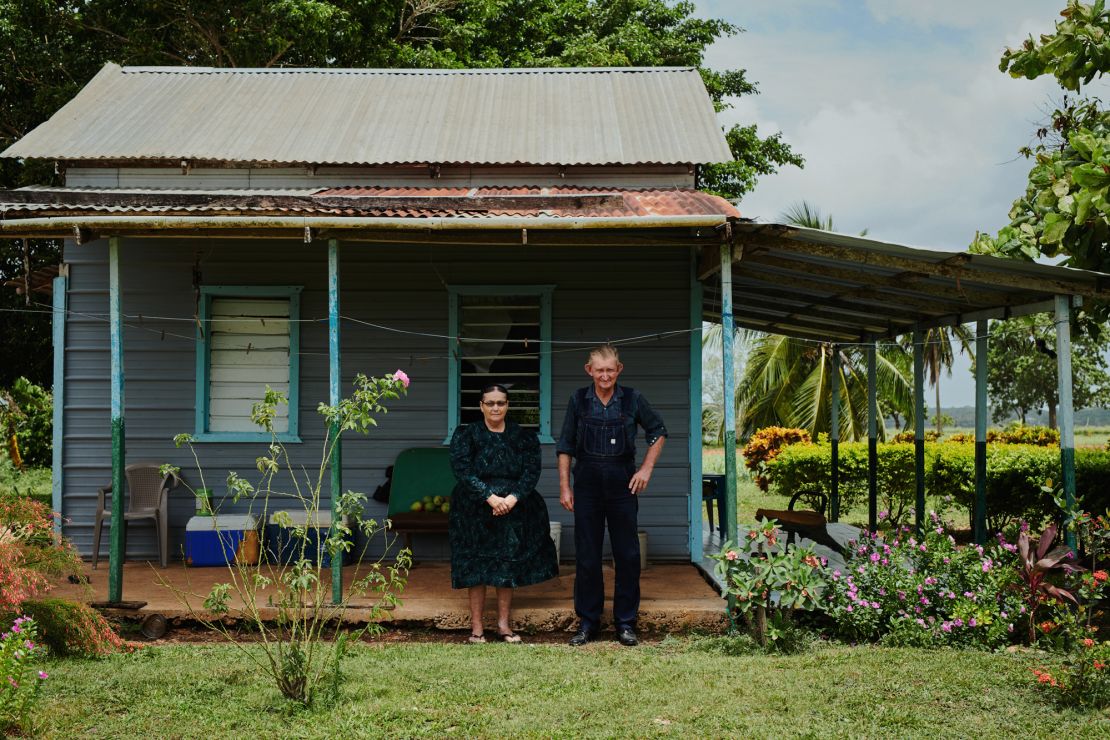 A husband and wife stand outside their home, with only the lush vegetation hinting at the photo's surprising location: Belize. "Seventy-five percent of the images could be presented in a way where you would never know it's the tropics," said photographer Jake Michaels.