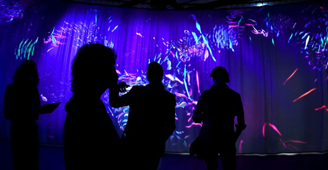 Visitors walk through the exibition "After Nature."