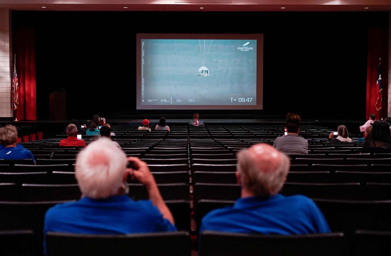 The capsule's descent is seen during a watch party in Van Horn, Texas.