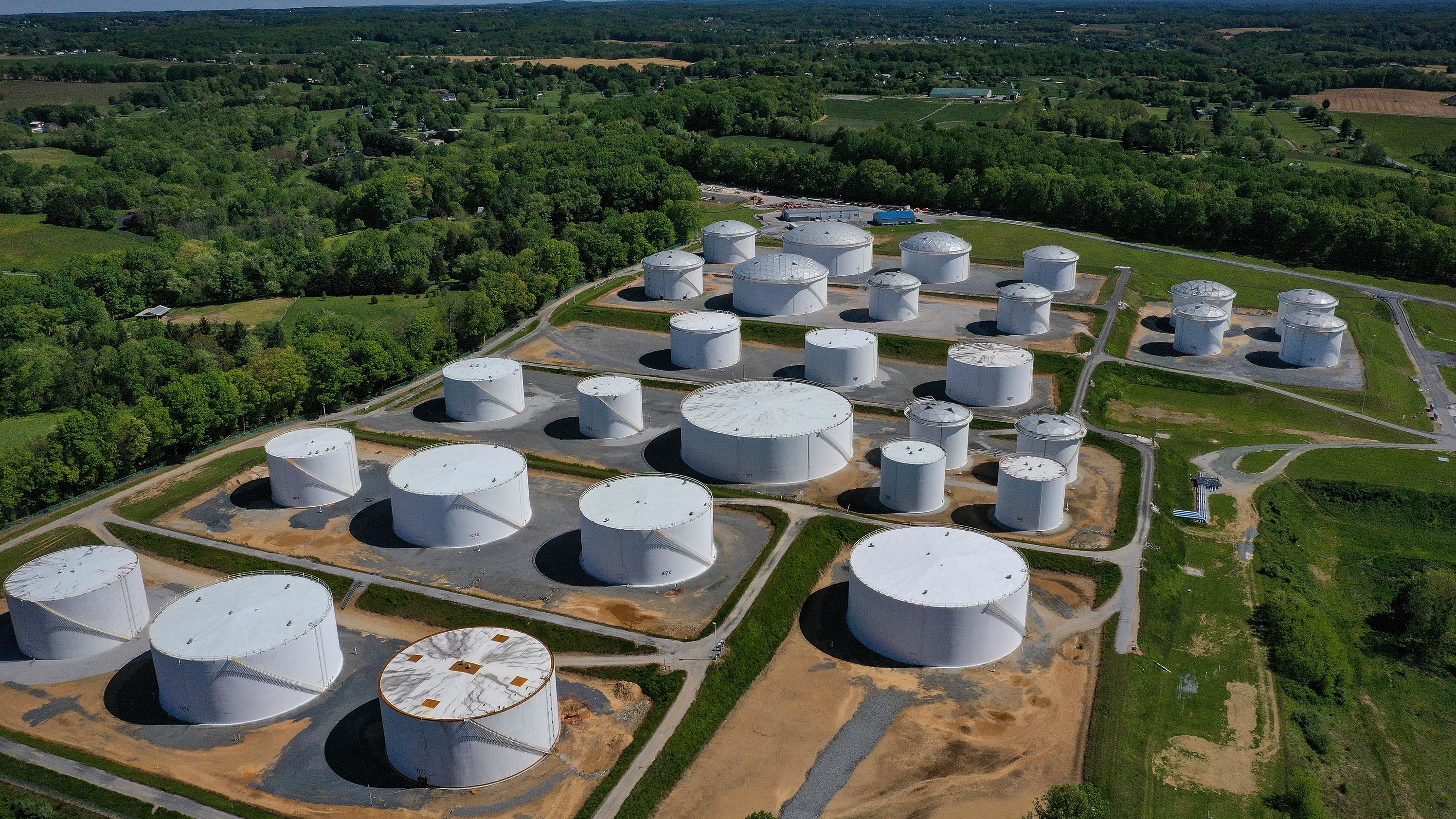 In an aerial view, fuel holding tanks are seen at Colonial Pipeline's Dorsey Junction Station on May 13, 2021 in Woodbine, Maryland. 