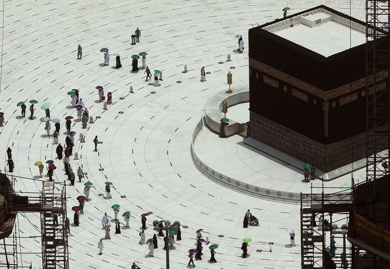 Worshippers walk around the Kaaba, Islam's holiest shrine, at the Grand Mosque in Mecca, Saudi Arabia, on Tuesday, July 20.