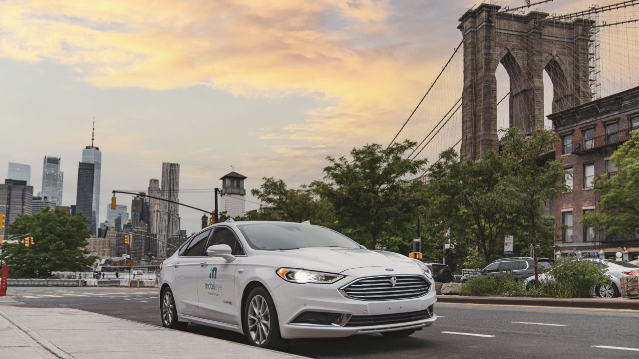 A self-driving vehicle from Mobileye's autonomous test fleet sits parked in front of the Manhattan Bridge in June 2021. Mobileye tests its technology in complex urban areas in preparation for future driverless services. (Credit: Mobileye, an Intel Company)