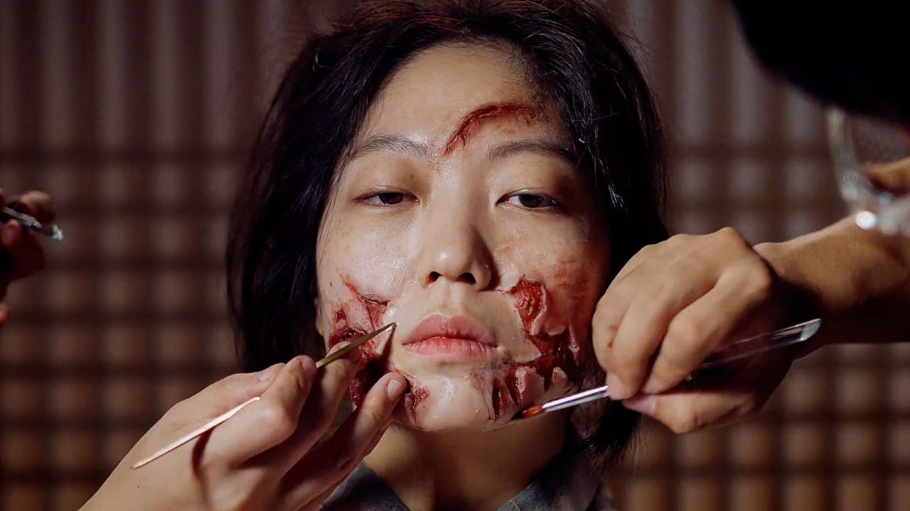 A special effects artist applies zombie makeup to actor for the South Korean Netflix series, Kingdom.