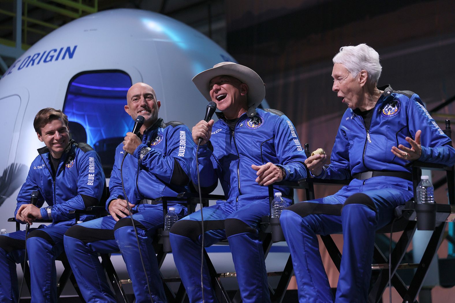 From left, Oliver Daemen, Mark Bezos, Jeff Bezos and Wally Funk hold a news conference after flying into space. "My expectations were high, and they were dramatically exceeded," Jeff Bezos said.