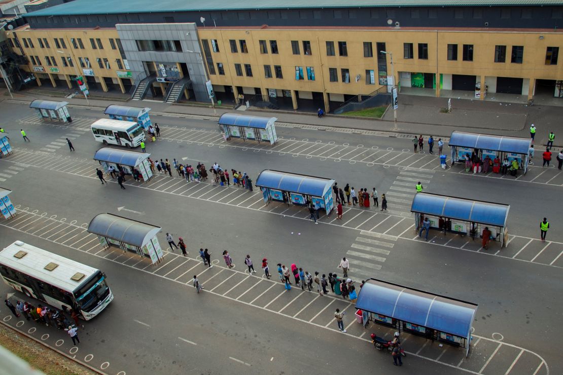 People wait for buses at a bus station in Kigali, capital city of Rwanda, on July 1.