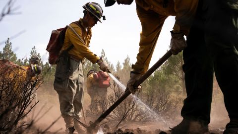 Firefighters extinguish hot spots in an area affected by the Bootleg Fire near Bly, Oregon.