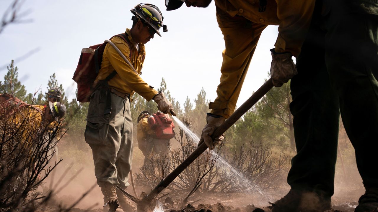 Firefighters extinguish hotspots in an area hit hard by the Bootleg Fire near Bly, Oregon, on July 19.