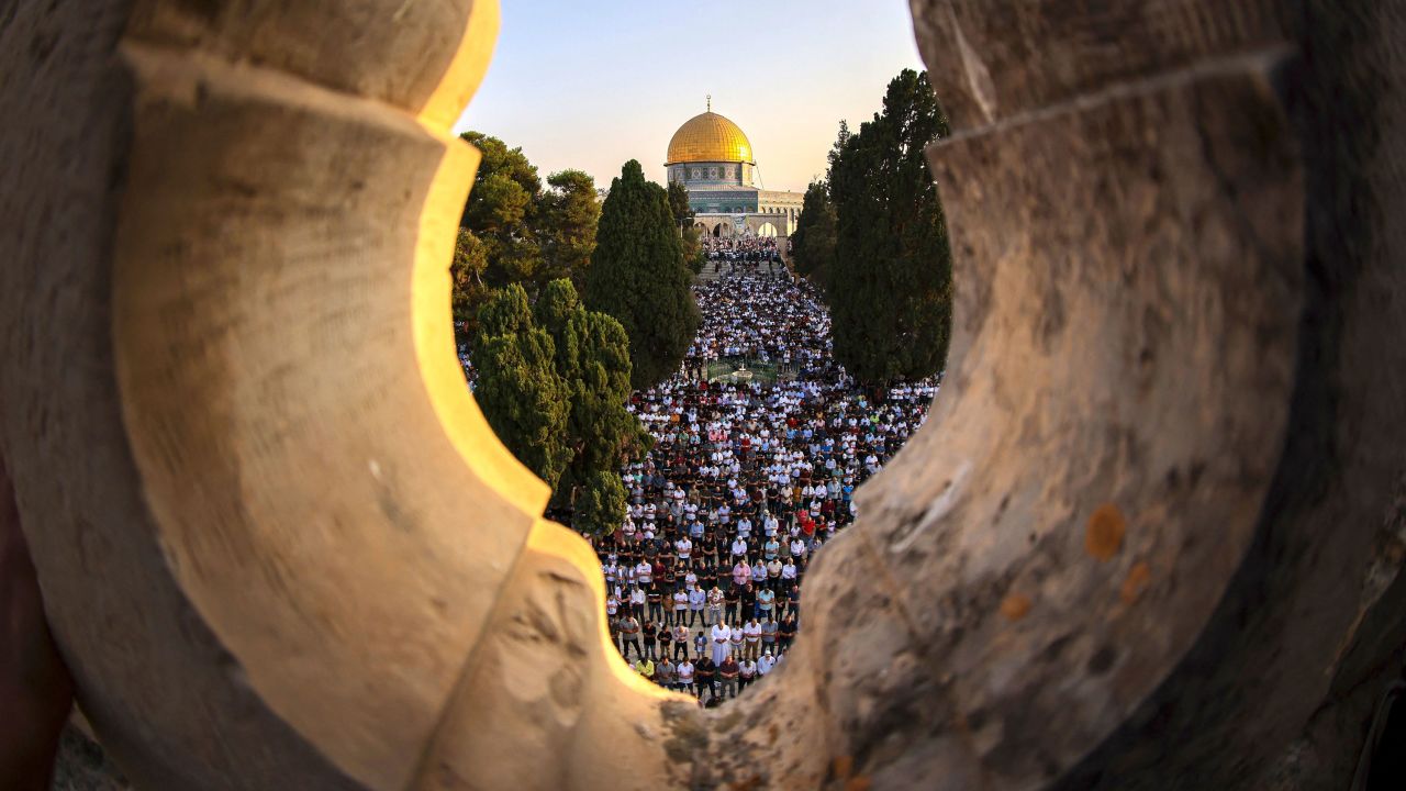 Palestinian worshipers perform the al-Adha feast prayer at the al-Aqsa Mosque complex in Jerusalem's old city, on the first day of the feast celebrated by Muslims worldwide, on July 20, 2021. The Eid al-Adha, or "Feast of Sacrifice," marks the end of the annual pilgrimage or Hajj to the Saudi holy city of Mecca and is celebrated in remembrance of Abraham's readiness to sacrifice his son to God.