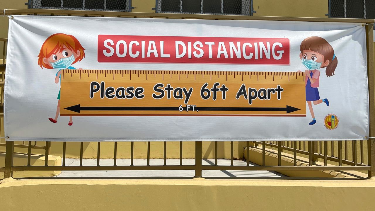 A social distancing sign hangs at Morris K. Hamasaki Elementary School in Los Angeles on July 1.