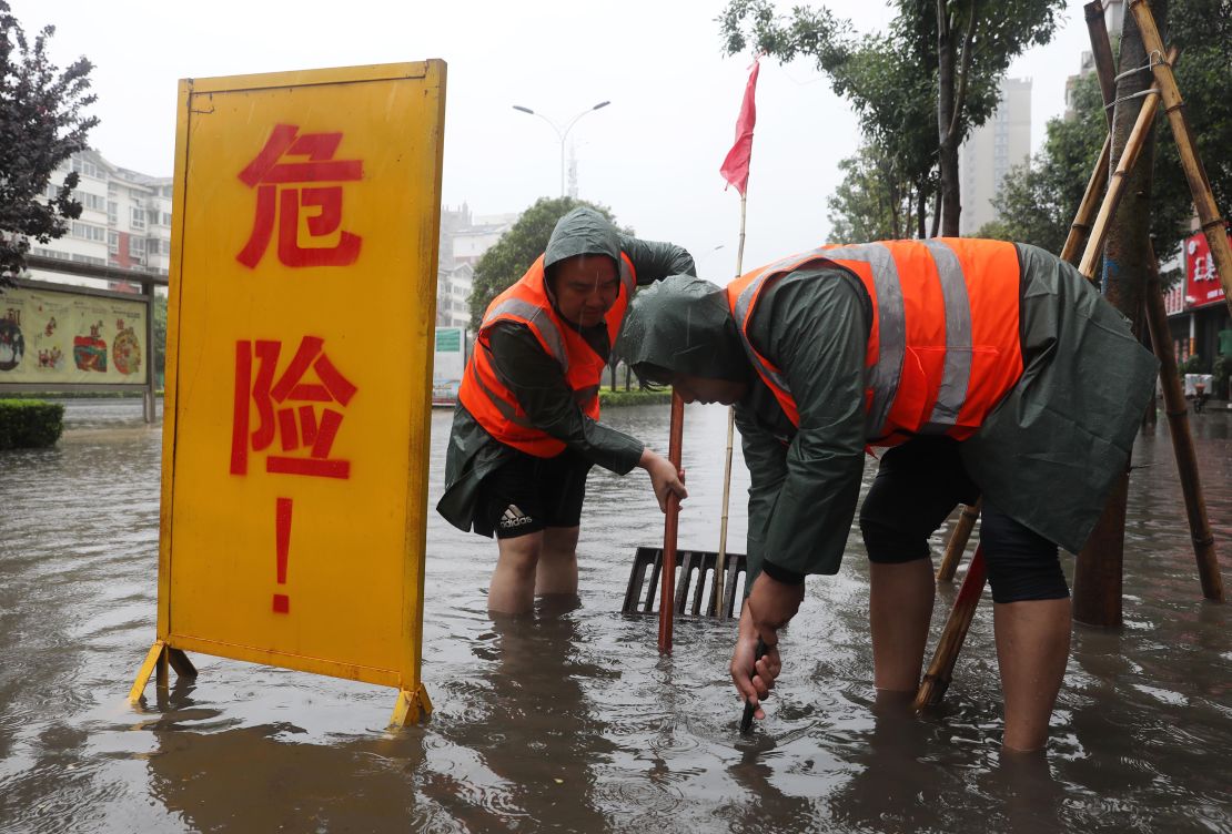 Workers drain water from a waterlogged area in Lanzhou, Henan, China, on July 20. 