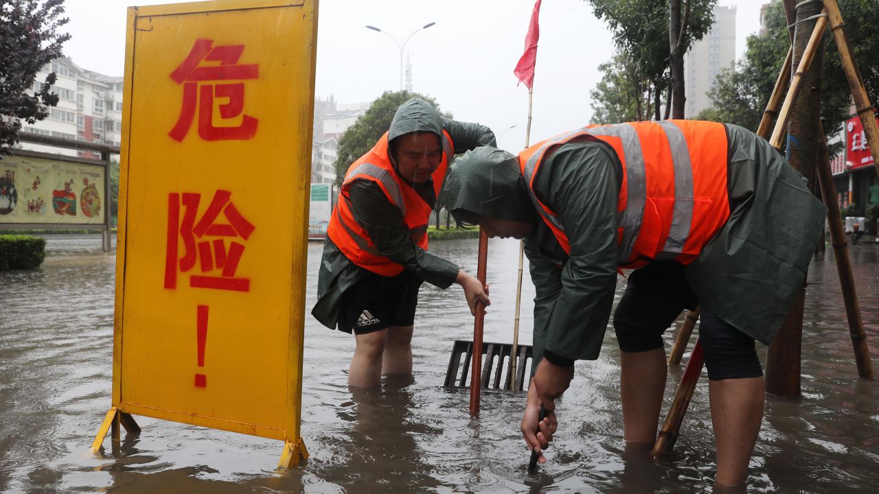 Workers drain water from a waterlogged area in Lanzhou, Henan, China, on July 20.