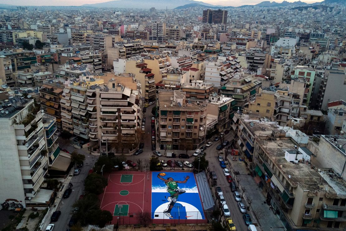 Artwork of Giannis Antetokounmpo on a basketball court in Athens.