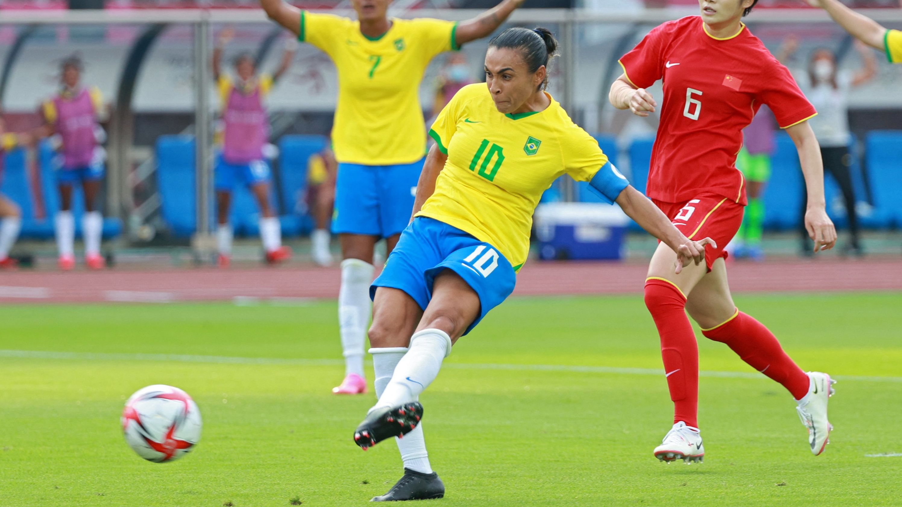 Brazil's midfielder Marta shoots to score the opening goal during the match against China.