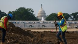 Workers repair a park near the Capitol in Washington, Wednesday, July 21, 2021, as senators struggle to reach a compromise over how to pay for nearly $1 trillion in public works spending, a key part of President Joe Biden's agenda. (AP Photo/J. Scott Applewhite)