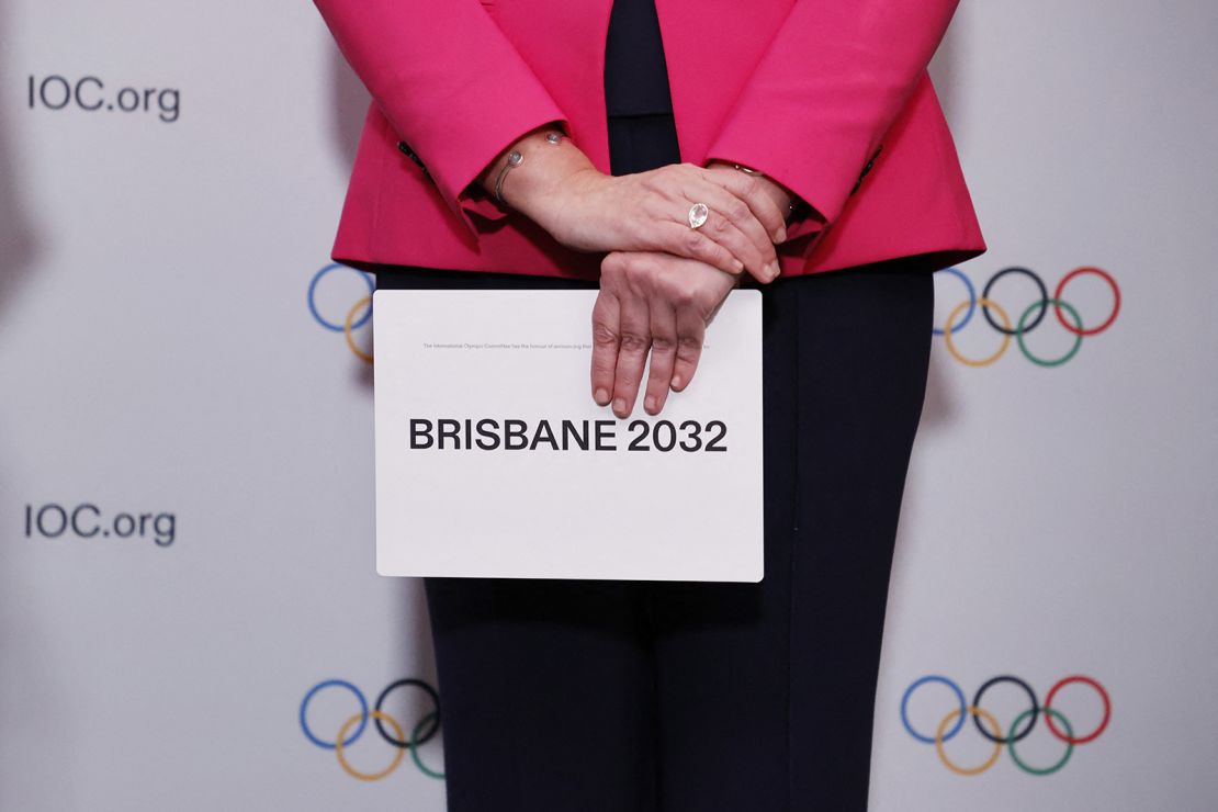 Queensland Premier Annastacia Palaszczuk holds a queue card after the Brisbane announcement during an IOC session in Tokyo.