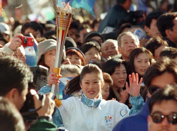 American Olympic ice skater Kristi Yamaguchi runs the torch through the streets of Nagano, Japan, in 1998.