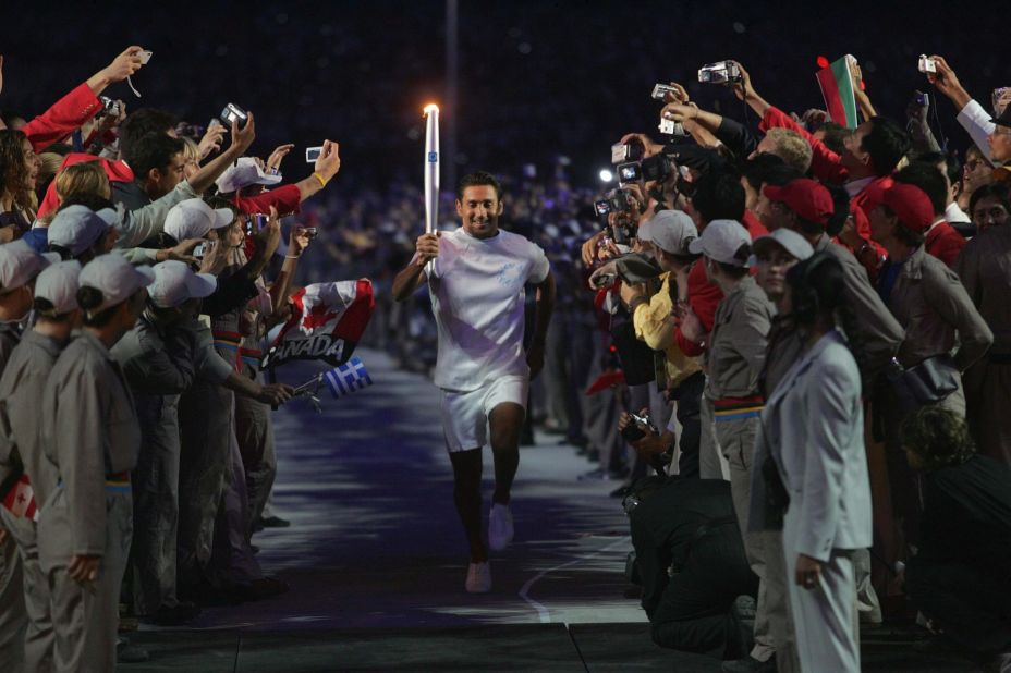 Olympic athlete Nikolaos Kaklamanakis carries the torch for the 2004 Summer Games in Athens.