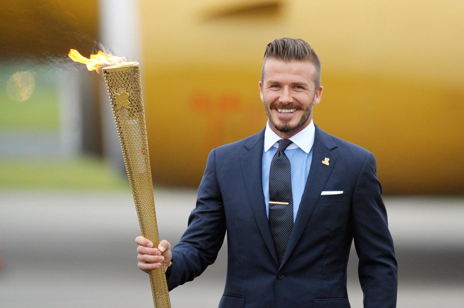 David Beckham with the Olympic torch in the 2012 London Summer Games. 