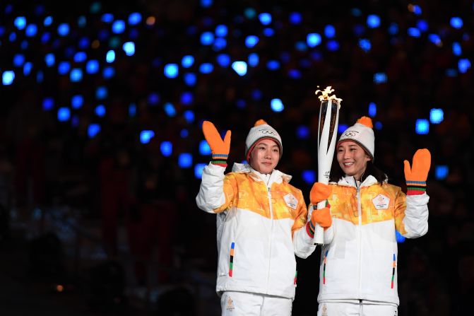 Torchbearers carry the Olympic flame during the opening ceremony of the Pyeongchang 2018 Winter Olympic Games.