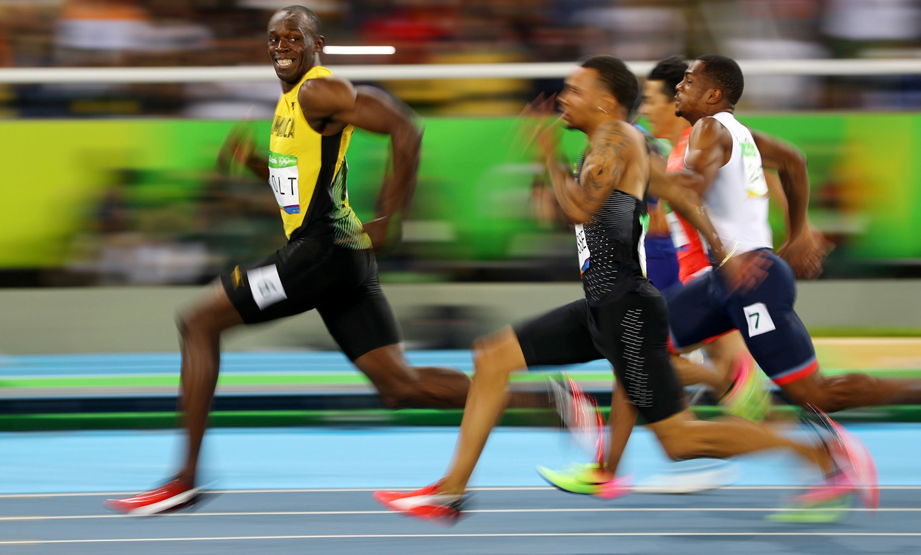 Jamaican sprinter Usain Bolt looks back at his Olympic competitors during a 100-meter semifinal in 2016. Bolt won the final a short time later, becoming the first man in history to win the 100 meters at three straight Olympic Games. Bolt, the world-record holder in the 100 and 200 meters, won eight gold medals during his legendary Olympic career.