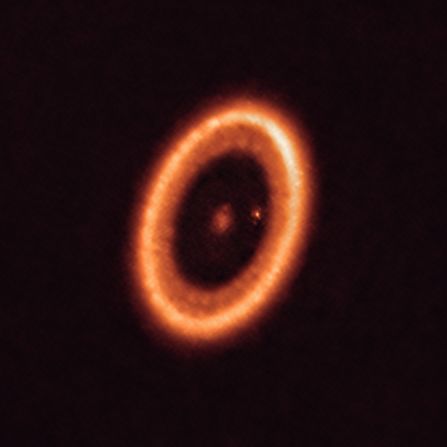 This image, taken with the Atacama Large Millimeter/submillimeter Array in Chile, shows the PDS 70 system 400 light-years away. This planetary system is still forming and still in the process of being formed. One of the planets in the system has a moon-forming disk around it.