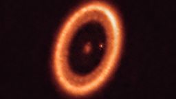 This image, taken with the Atacama Large Millimeter/submillimeter Array (ALMA), in which ESO is a partner, shows the PDS 70 system, located nearly 400 light-years away and still in the process of being formed. The system features a star at its centre and at least two planets orbiting it, PDS 70b (not visible in the image) and PDS 70c, surrounded by a circumplanetary disc (the dot to the right of the star). The planets have carved a cavity in the circumstellar disc (the ring-like structure that dominates the image) as they gobbled up material from the disc itself, growing in size. It was during this process that PDS 70c acquired its own circumplanetary disc, which contributes to the growth of the planet and where moons can form.