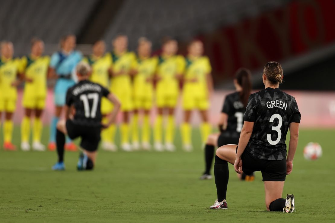 Anna Green in the New Zealand team's No. 3 jersey takes a knee along with her teammates before the game against Australia.