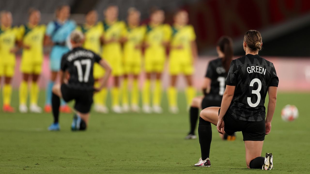 Anna Green in the New Zealand team's No. 3 jersey takes a knee along with her teammates before the game against Australia.
