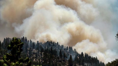 Smoke rises from the Dixie Fire burning along Highway 70 in Plumas National Forest on July 16, 2021