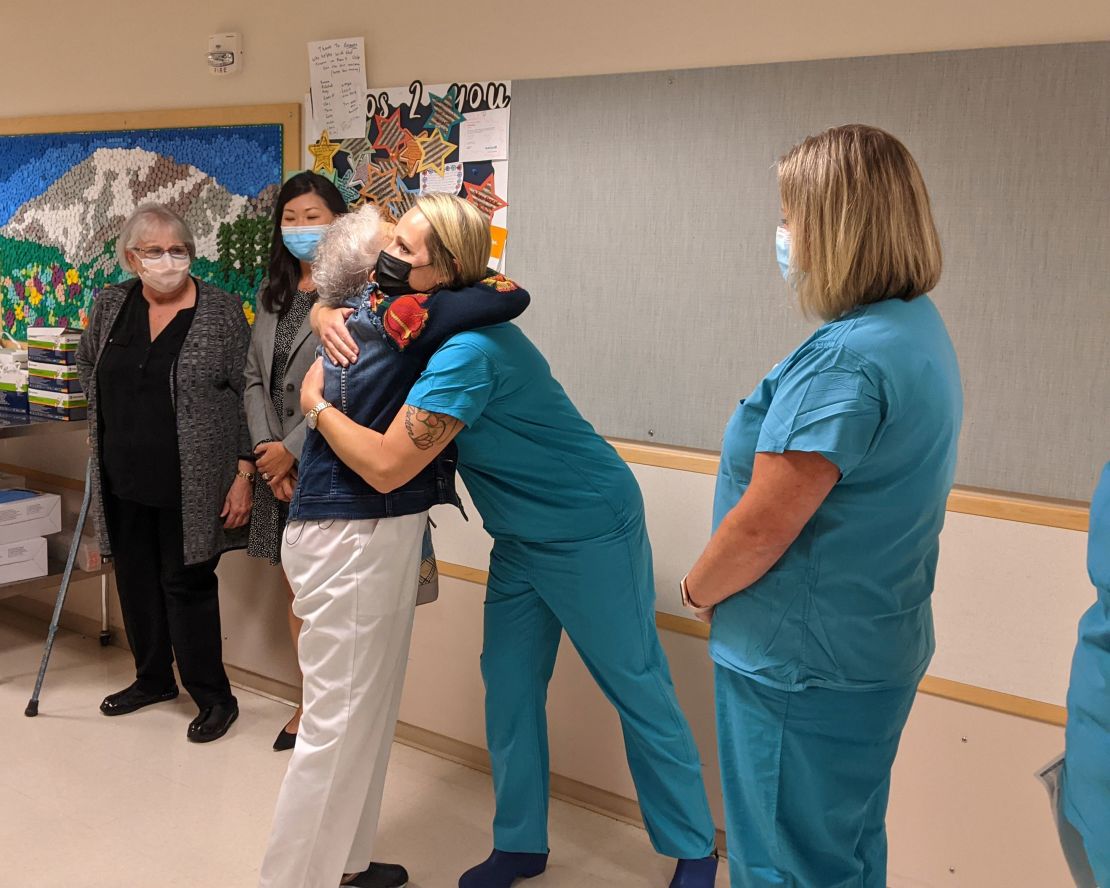 Rigney, pictured here hugging another staff member on her last day.