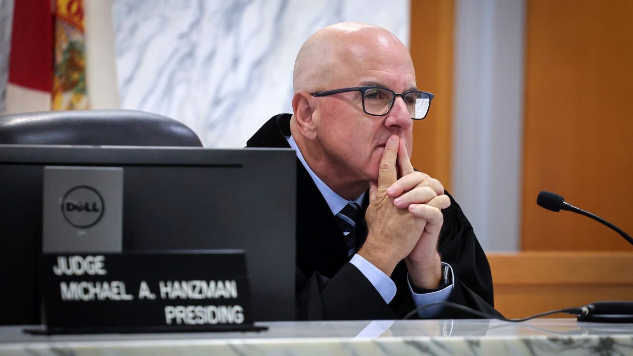 Miami-Dade Circuit Judge Michael Hanzman listens as tenants and condo owners share their thoughts on the site of the Champlain Towers South building that collapsed in Surfside, Florida.