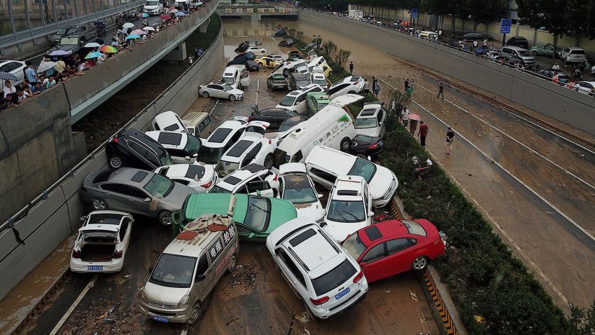 TOPSHOT - An aerial view shows cars sitting in floodwaters at the entrance of a tunnel after heavy rains hit the city of Zhengzhou in China's central Henan province on July 22, 2021. (Photo by Noel Celis / AFP) (Photo by NOEL CELIS/AFP via Getty Images)