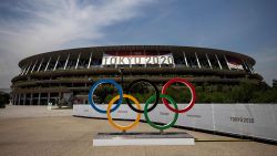 TOPSHOT - This picture shows the Olympic rings and Olympic Stadium in Tokyo on July 20, 2021, ahead of the Tokyo 2020 Olympic Games. (Photo by Behrouz MEHRI / AFP) (Photo by BEHROUZ MEHRI/AFP via Getty Images)
