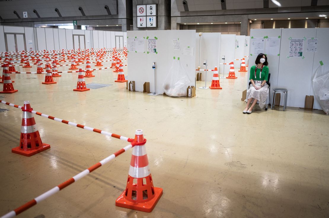 A journalist sits at the Covid-19 testing area of the Olympic media center in Tokyo.