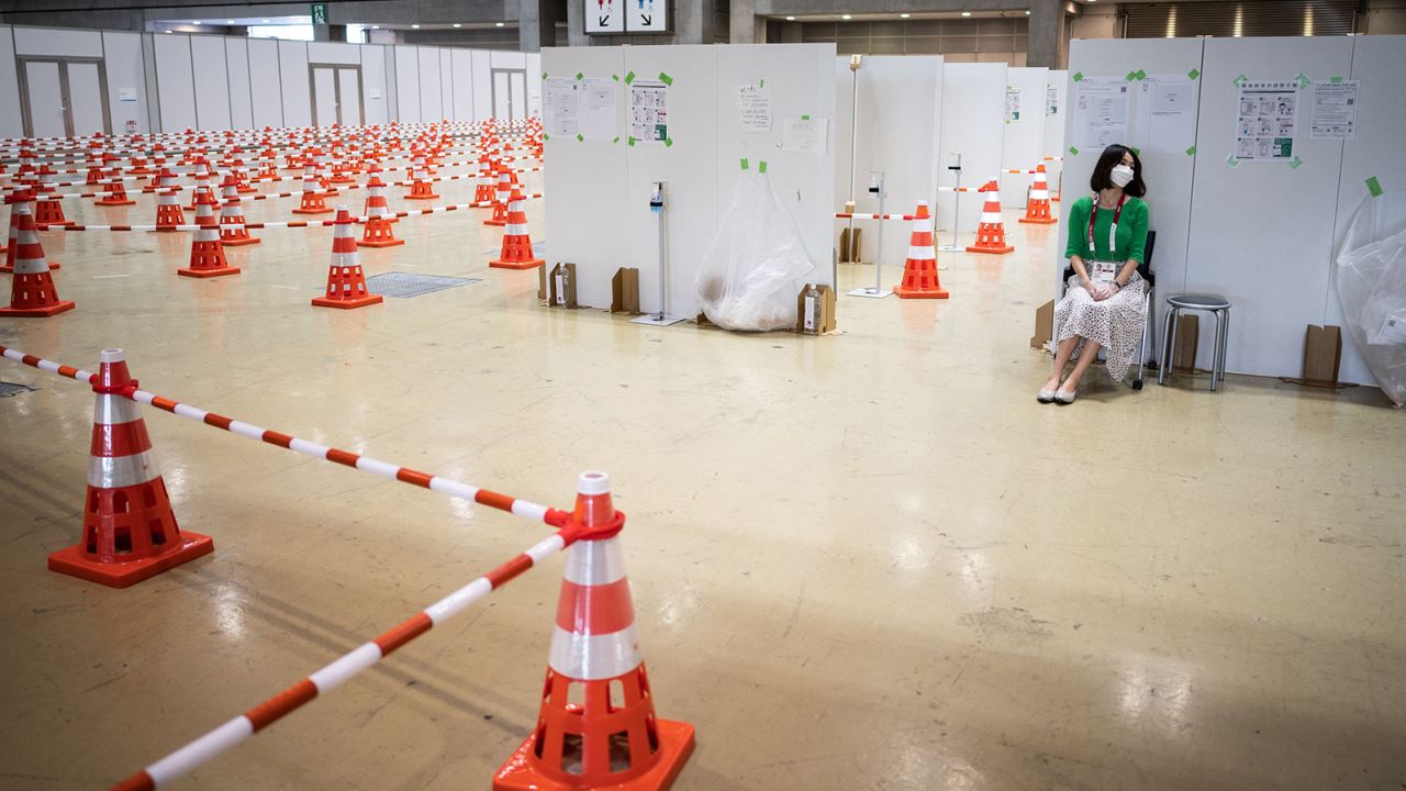 A journalist sits at the Covid-19 testing area of the Olympic media center in Tokyo.