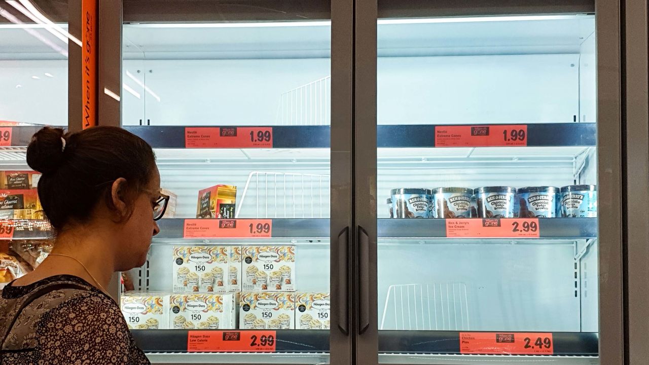 A customer looks at the depleted stock of ice cream at a Lidl supermarket.