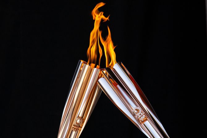 Torchbearers exchange the flame in Tokyo, Japan.