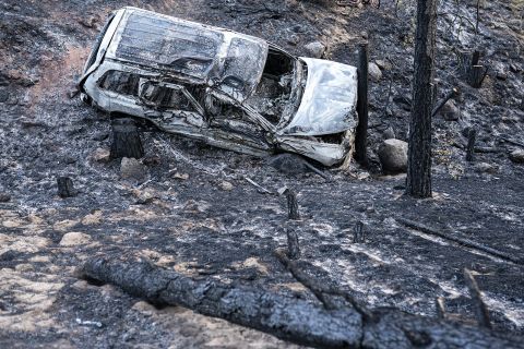 A car is charred by the Bootleg Fire along a mountain road near Bly, Oregon.