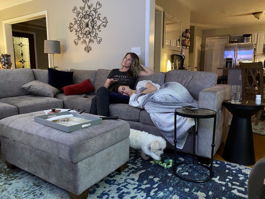 Morgan Stephens lies next to her mother at home in December 2020.