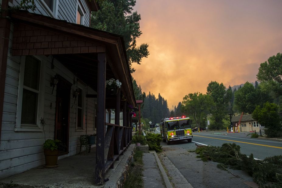 Firefighters work to protect Markleeville, California, from the Tamarack Fire on July 17. The Tamarack Fire was started by a lightning strike. 