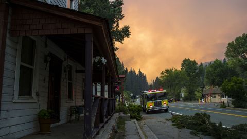 Firefighters work to protect Markleeville, California, from the Tamarack Fire on July 17. The Tamarack Fire was started by a lightning strike. 