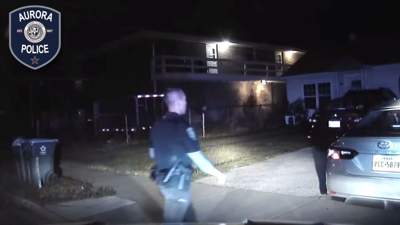 This screen grab from a dash camera video, released by Aurora, Illinois, police, shows an officer approaching a car while initiating a traffic stop.