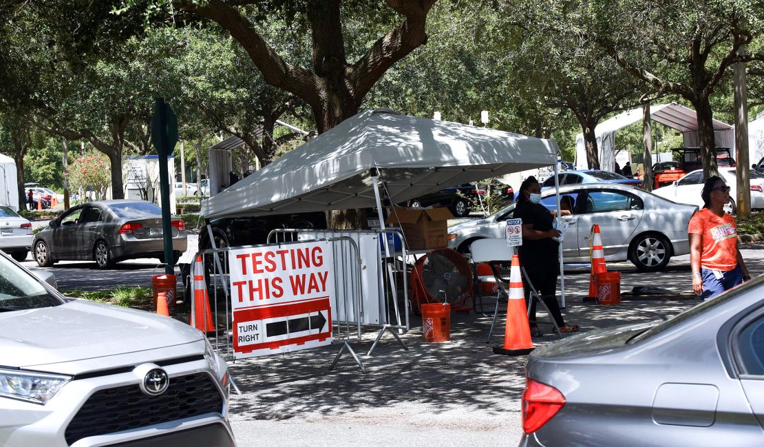 People wait at a testing and vaccination site in Barnett Park, Florida. One in five of all cases in the US are occurring in the state, White House officials say.