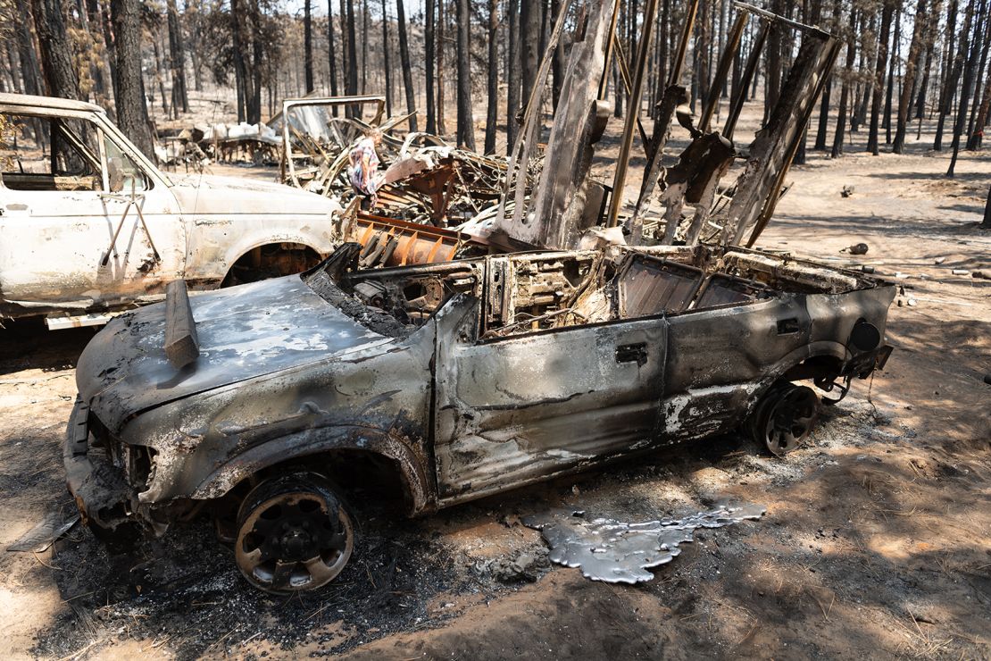 Dee McCauley surveys charred wreckage Thursday on her property in Bly, Oregon.