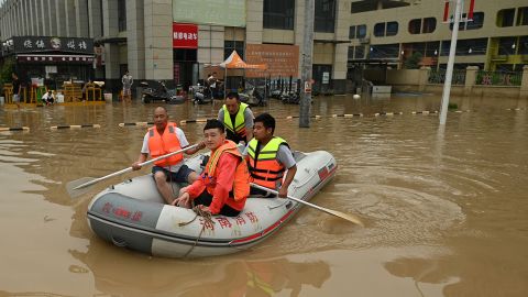 Rescue workers paddle through a flooded street in Zhengzhou, China, on July 23.