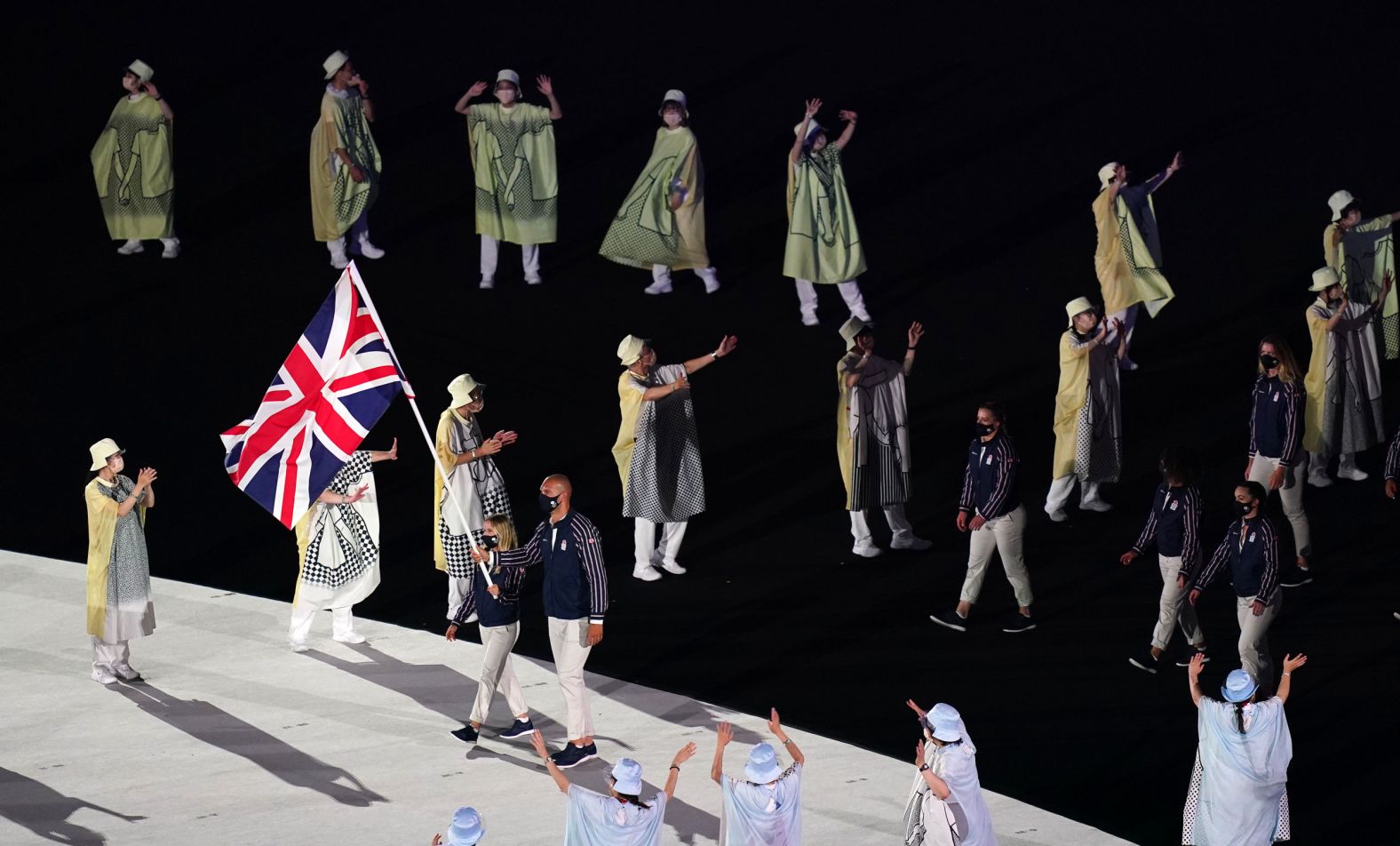 British flag-bearers Hannah Mills and Mohamed Sbihi lead out the team during the opening ceremony's parade of nations. Sbihi, a rower, made history as Great Britain's first Muslim flag-bearer.