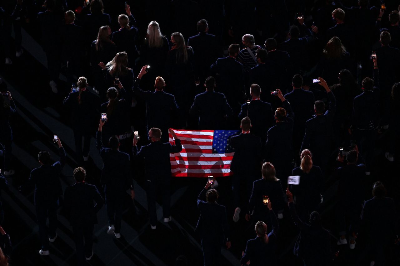 US athletes hold an American flag during the parade of nations.