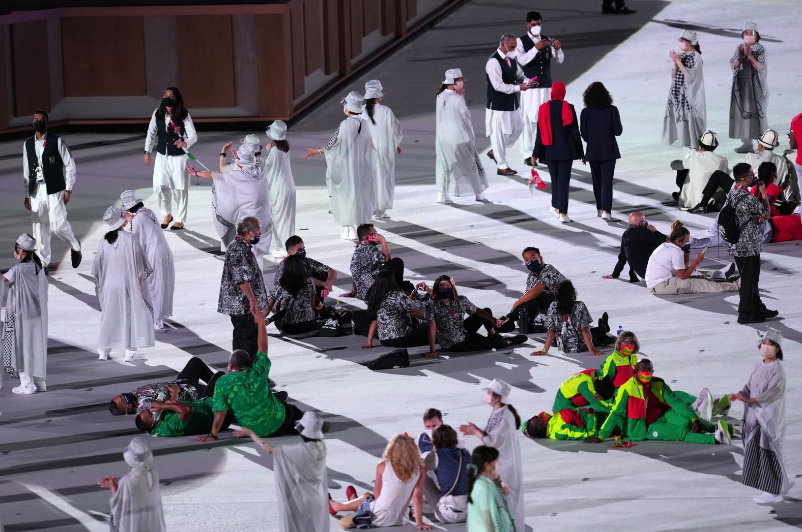 Athletes from various nations sit during the opening ceremony.