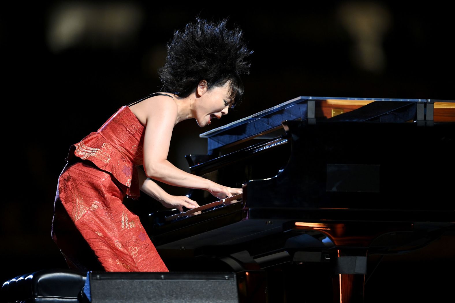 Japanese jazz composer Hiromi Uehara plays the piano during the opening ceremony.